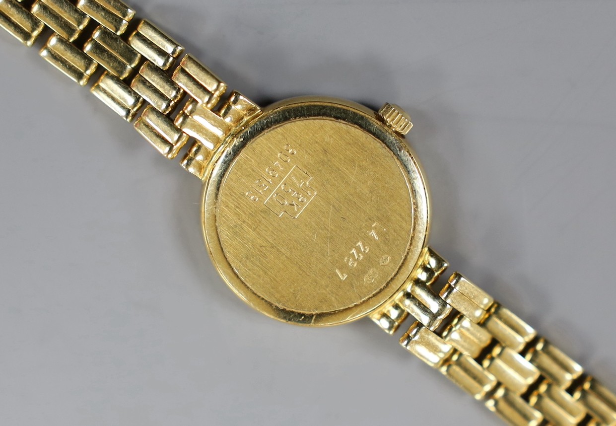 A lady's 18ct gold Longines quartz wrist watch, with mother of pearl dial and diamond chip set bezel, on an 18ct gold Longines bracelet, approx. 16cm, gross weight 33.2 grams, no box or papers.